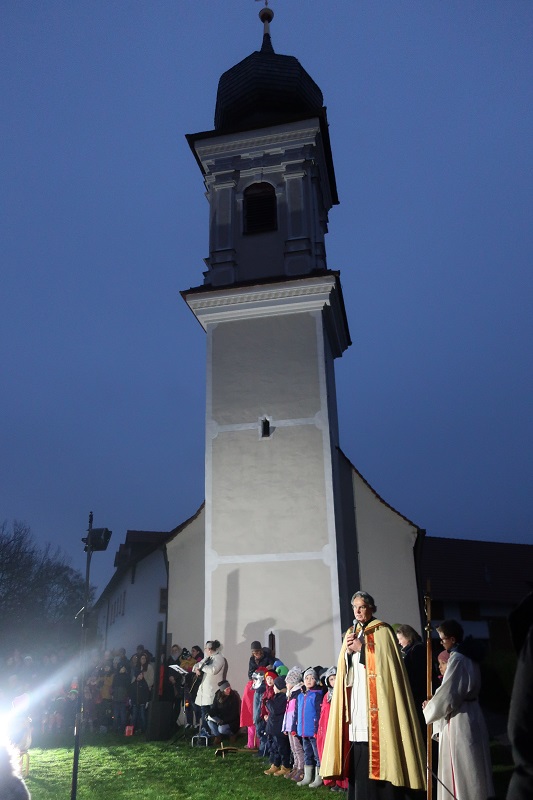 An der Peterskirche findet eine Andacht zum Martinsfest statt, bei der Herr Pfarrer Bartkowski die Laternen der Kinder segnet.