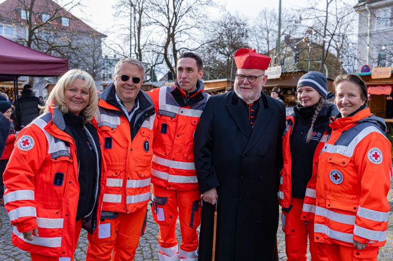 Kardinal Marx mit den Sanitätern des Roten Kreuzes, die den Gottesdienst begleitet haben