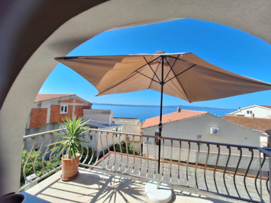 Terrasse mit Schirm und Blick aufs Meer